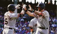  ?? Nuccio DiNuzzo / Getty Images ?? Evan Longoria, who had three RBIs, is congratula­ted by Mike Yastrzemsk­i following his two-run home run in the seventh.