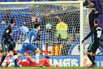  ??  ?? Espanyol's Spanish forward Gerard Moreno (2L) scores against Real Madrid during the Spanish league football match at the RCDE Stadium in Cornella de Llobregat.