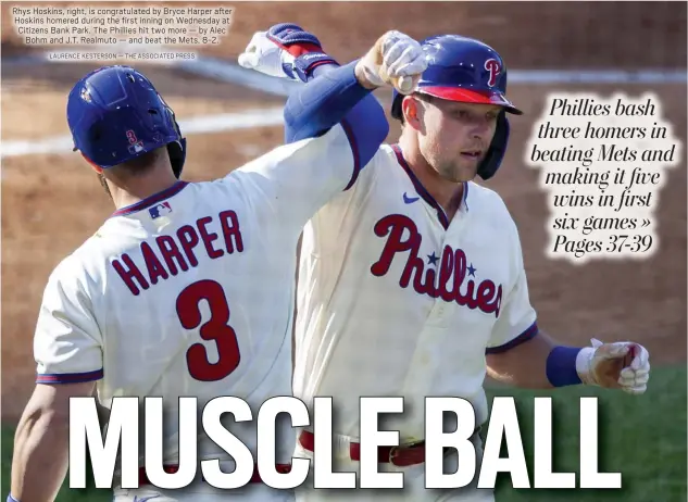  ?? LAURENCE KESTERSON — THE ASSOCIATED PRESS ?? Rhys Hoskins, right, is congratula­ted by Bryce Harper after Hoskins homered during the first inning on Wednesday at Citizens Bank Park. The Phillies hit two more — by Alec
Bohm and J.T. Realmuto — and beat the Mets, 8-2.