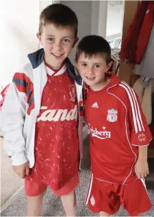  ??  ?? Tristan and Rowan Murphy. Tristan is wearing his Dad’s kit from 30 years ago. Both boys are over the moon as is their dad James Murphy.