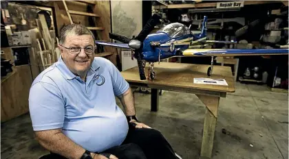  ?? DAVID UNWIN/STUFF ?? Palmerston North Aeroneers vicepresid­ent Rene Redmond, with one of the models he plans to fly at the club open day this Sunday – a quartersca­le Tucano fighter plane.