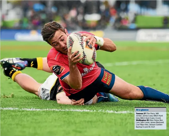  ?? PHOTOSPORT ?? First five-eighth Mitch Hunt crosses for the match-winning try in Tasman’s 37-35 win over Wellington yesterday in Blenheim.