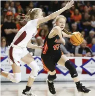  ?? (Arkansas Democrat-Gazette/Thomas Metthe) ?? Nashville's Shalyn Lyle (43) drives to the basket while guarded by Farmington's Marin Adams (2) during the second quarter of the Farmington's 65-61 win in the Class 4A girls state championsh­ip game at Bank OZK Arena in Hot Springs.