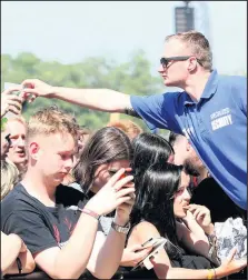  ??  ?? A security guard hands out water to fans on a hot day at Download Festival 2018. (Photo by Joseph Raynor/ Nottingham Post)