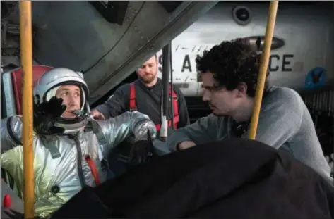  ?? UNIVERSAL PICTURES PHOTOS ?? Actor Ryan Gosling, who portrays Neil Armstrong in the new movie “First Man,” works with director Damien Chazelle during the shoot.