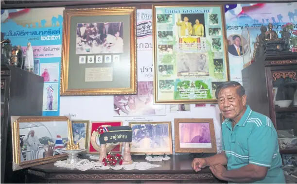  ?? APICHIT JINAKUL ?? Maj Gen Pramote Rattanopas shows off mementos and framed photos of landmark events in his life and career as an army soldier, which are kept at his home in Chon Buri. Some of his most cherished memories are of his military service devoted to the late King Bhumibol Adulyadej who visited the North during the height of the communist insurgency many decades ago. Maj Gen Pramote was one of the troops stationed in Chiang Rai where the late King made a visit.
