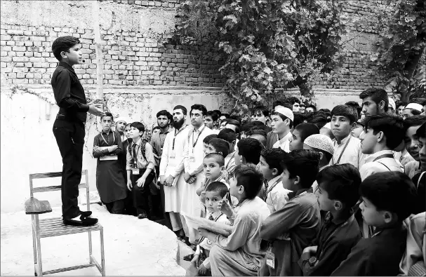  ??  ?? Hammad lectures students at a languages academy in Peshawar.