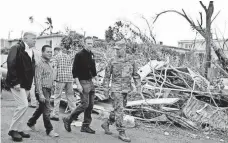  ?? EVAN VUCCI, AP ?? President Trump surveys hurricane damage and recovery efforts Tuesday in Guaynabo, Puerto Rico.