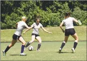  ?? PHOTO COURTESY OF COLLEGE OF SOUTHERN MARYLAND ?? College Of Southern Maryland sophomore Julia Lesko, a McDonough High School graduate, looks for an open teammate during a recent Hawks practice as fellow players Elizabeth Schwenk, a Northern High School pictured at left, and Danielle Bowling, a La...