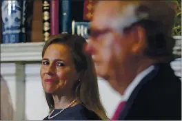  ?? POO — SUSAN WALSH ?? Supreme Court nominee Judge Amy Coney Barrett looks over at Senate Majority Leader Mitch McConnell of Kentucky as they meet with on Capitol Hill in Washington on Tuesday.