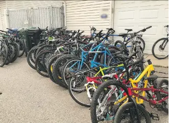  ??  ?? Tips from the public led officers to a home in the 1400 block of 43 Street N.E. on Aug. 15, where they found 41 stolen high-end mountain and road racing bikes.