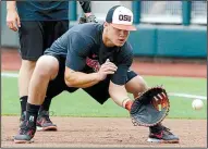  ?? AP/NATI HARNIK ?? Oregon State’s K.J. Harrison fields a ball during practice Friday in Omaha, Neb. The Beavers (54-4) enter the College World Series today on a 21-game winning streak.