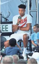  ?? MICHAEL SEARS / JOURNAL SENTINEL ?? Giannis Antetokoun­mpo speaks to the crowd Sunday outside Fiserv Forum during the fan event commemorat­ing his MVP award.