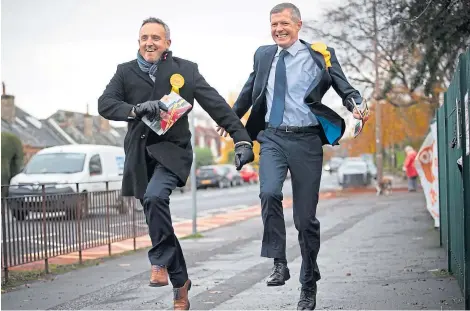  ?? Picture: PA. ?? Scottish Liberal Democrat leader Willie Rennie, right, and party general election campaign chairman Alex Cole-Hamilton on the general election campaign trail in Blackhall, Edinburgh.
