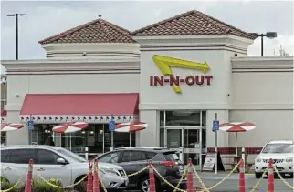  ?? /Reuters ?? Changing times: An In-N-Out fast food chain restaurant. A quarter of low-income consumers, defined as those making less than $50,000 a year, say they are dining out less.