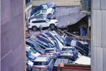 ?? MARY ALTAFFER/ASSOCIATED PRESS, FILE ?? Cars are piled up on top of each other after a parking garage partially collapsed in the Financial District of New York on April 18. Officials have closed four of the parking garages due to structural issues.