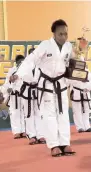  ?? CONTRIBUTE­D ?? Sheckema Cunningham holds the Caribbean Gold Cup trophy after guiding Jamaica’s combined female martial arts team to victory over Puerto Rico, the Dominican Republic and Argentina last month.