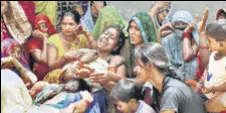  ?? ANI ?? Relatives of the deceased mourn, at Khevrajpur village, near Prayagraj on Saturday.