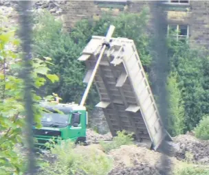  ??  ?? ●●A lorry dumps waste at the former Turners Brothers site