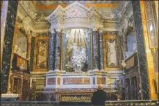  ??  ?? A visitor admires the marble sculptural group “Ecstasy of Saint Teresa” made between 1647 and 1652 by Baroque architect and sculptor Gian Lorenzo Bernini in the Cornaro Chapel of Rome’s Saint Mary of Victory church.