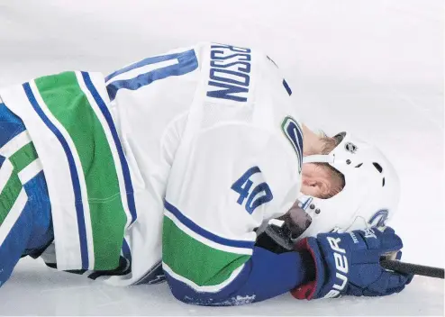  ?? — CP ?? Canucks rookie Elias Pettersson lies on the ice after hurting his leg during the second period on Thursday at the Bell Centre in Montreal. Pettersson left the ice on his own power, but it remains to be seen if the injury is serious.