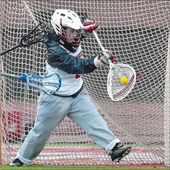  ?? TIM MARTIN/THE DAY ?? NFA goalie Jillian Brunelli makes one of her five saves during the Wildcats’ 9-1 victory over RHAM in a non-league girls’ lacrosse game on Tuesday in Norwich.