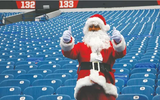  ?? MICHAEL ADAMUCCI/ GETTY IMAGES ?? Although empty seats have predominat­ed at stadiums this season due to COVID-19, Santa Claus has used his considerab­le influence to gain access.