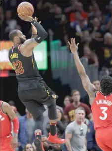  ?? AP ?? LeBron James hits the game- winning shot against Raptors forward OG Anunoby to put the Cavaliers up 3- 0 in their second- round series.
