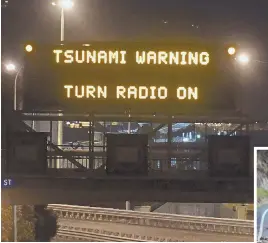  ?? PHOTO, ABOVE, BY ROSS SETFORD/SNPA VIA AP ?? WARNINGS: A road sign warns motorists of tsunami waves after a 7.8-magnitude quake struck New Zealand early this morning. At right, a road is cordoned off near the Waiau Ferry Bridge near Hanmer Springs, New Zealand.