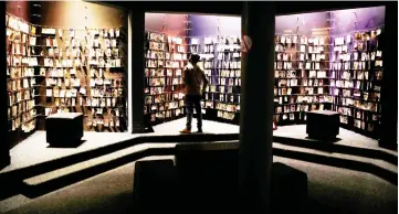  ??  ?? A visitor looks at an exhibition displaying pictures of the Rwandan Genocide victims donated by survivors at the Genocide Memorial in Gisozi in Kigali. — Reuters photo