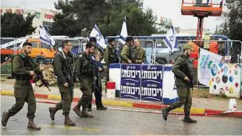  ?? Reuters ?? Oppressors claiming to be victims Israeli occupation soldiers patrol the scene after killing a Palestinia­n who allegedly tried to stab a man near a West Bank colony yesterday. The location has seen many attacks in two months.