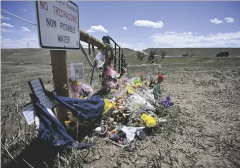  ?? ERIC LUTZENS/THE DENVER POST VIA AP ?? A roadside memorial for Alexa Bartell, age 20, who was killed by a rock thrown at her vehicle on April 19 stands on April 28, in Broomfield, Colo.