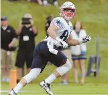  ?? STAFF PHOTO BY JOHN WILCOX ?? LOOKING UP SO FAR: Wide receiver Austin Carr tracks a pass during yesterday’s first day of Patriots training camp at Gillette Stadium.