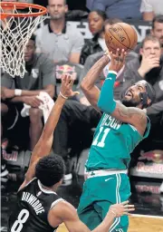  ?? EPA ?? The Celtics’ Kyrie Irving drives to the basket as the Nets’ Spencer Dinwiddie defends during the first half of their NBA game at the Barclays Center in Brooklyn.