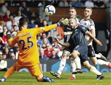  ??  ?? Manchester City’s Sergio Aguero (second from right) scores past Fulham goalkeeper Sergio Rico at Craven Cottage yesterday. AFP PIC