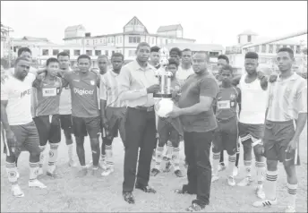 ??  ?? Petra Organisati­on Co-Director Troy Mendonca (right) presenting the ball and trophy to President of Circuit Ville Youth & Sports Club President Owan Wills in the presence of club players.