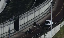  ?? MOISES CASTILLO — THE ASSOCIATED PRESS FILE ?? Honduran asylum seekers are taken into custody by U.S. Border Patrol agents after the group crossed the U.S. border wall into San Diego, seen from Tijuana, Mexico.