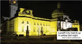 ?? MATTHEW HORWOOD ?? Cardiff City Hall lit up in yellow last night