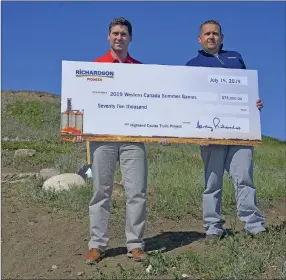  ??  ?? BJ Krywulak, Director of Operations for Richardson Pioneer in Swift Current presented a $75,000 Signature Partnershi­p contributi­on to Scott Cassidy, Director of Friends of the Games.