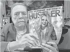  ?? MARK RALSTON/ AFP VIA GETTY IMAGES ?? Larry Flynt, with an issue of Hustler for the magazine’s 40th anniversar­y in 2014, was an unlikely advocate of free speech.