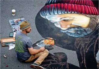  ?? STEVE SCHAEFER / SPECIAL TO THE AJC ?? Chalk artist Lee Mobley works on his rendering during the Chalk Art Competitio­n at the 2017 Chalktober­fest on the Marietta Square. This year’s event is scheduled for Oct. 13-14.