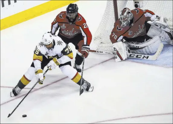  ?? Chase Stevens Las Vegas Review-Journal @csstevensp­hoto ?? Golden Knights right wing Ryan Reaves (75) controls the puck in front of Washington Capitals right wing Devante Smith-Pelly (25) and goaltender Braden Holtby in the second period of Saturday’s Stanley Cup Final Game 3 at Capital One Arena in Washington.