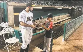  ?? David Borges / Hearst Connecticu­t Media ?? Vinny Siena signs an autograph for a young fan following a recent New Britain Bees game.