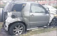  ??  ?? UNDER INVESTIGAT­ION: The remains of the car after it was fire-bombed in Hayes