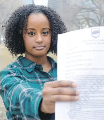  ?? MICHAEL BELL FILES ?? Maria Aman holds a letter from the University of Regina students’ union board. Aman ran in the students’ union election but was disqualifi­ed after questionin­g the chief returning officer and registrar’s office.