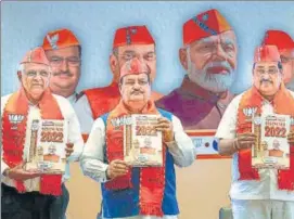  ?? PTI ?? (From left) Chief minister Bhupendra Patel, BJP national president JP Nadda and state party chief CR Patil release the party manifesto for assembly elections, in Gandhinaga­r.