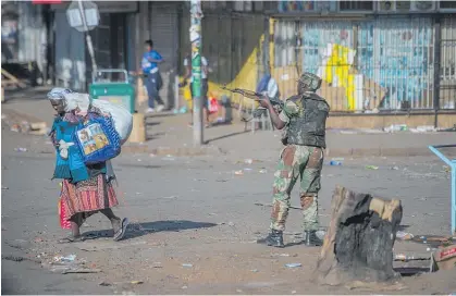  ?? Photo / AP ?? Armed soldiers took to the streets of Harare yesterday to break up protests by opposition supporters.