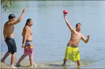  ?? Chris Kaufman ?? Junior Jason throws the football with friends on Monday at Beckwourth Riverfront Park in Marysville.