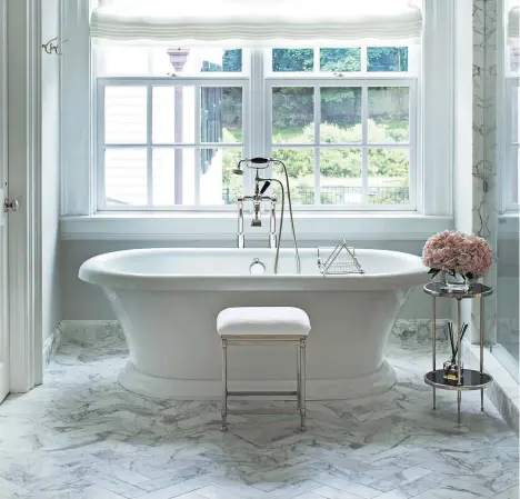  ?? JOHN BESSLER ?? If you’re the kind of person who loves a long soak, splurge on the most luxurious bathtub you can fit in your space.