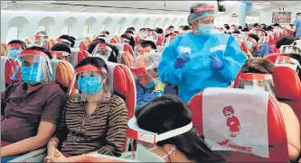 ?? TWITTER ?? On board a repatriati­on flight from Madrid, with masks and face shields the new reality. n